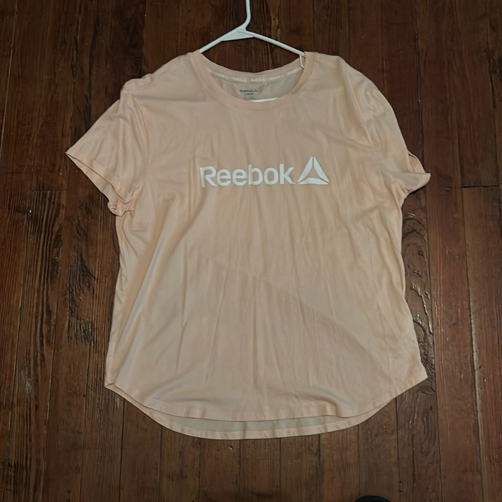 Women peach Reebok shirt size is large